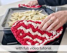 Load image into Gallery viewer, close up of red and white zig zag oven mitts and pan of French fries