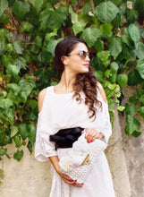 Load image into Gallery viewer, girl in white dress with green leaves behind her holding a crochet bag