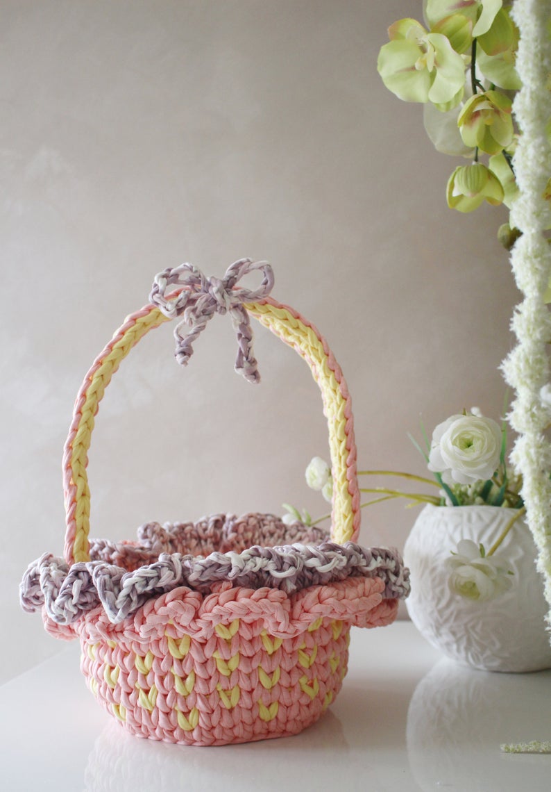 pink and purple crochet easter basket with a bow and ruffles 