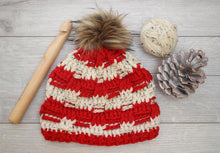Load image into Gallery viewer, red and white beanie with a big wooden crochet hook and pine cone
