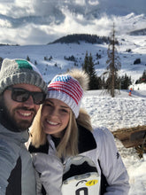 Load image into Gallery viewer, couple smiling skiing in the mountains wearing crochet hats 
