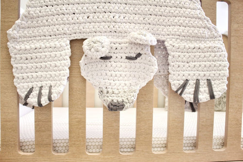 crochet bear rug hanging over a crib