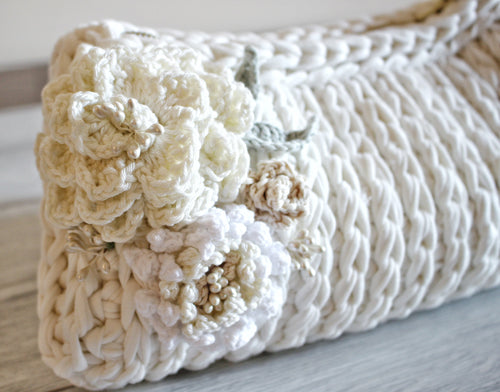 white crochet bag with pale crochet roses on the side