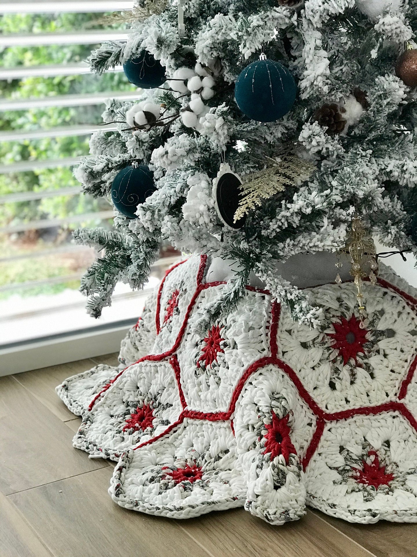 Red crochet Christmas tree skirt under a tree