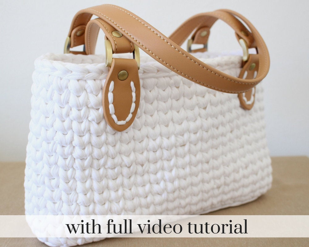 white crochet bag with brown leather straps