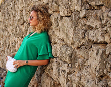 Load image into Gallery viewer, girl with green dress leaning against brick wall holding a crochet purse
