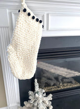 Load image into Gallery viewer, white crochet stocking with black pom pom border
