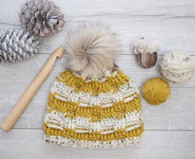 Load image into Gallery viewer, yellow crochet beanie with a furry pom pom and big crochet hook
